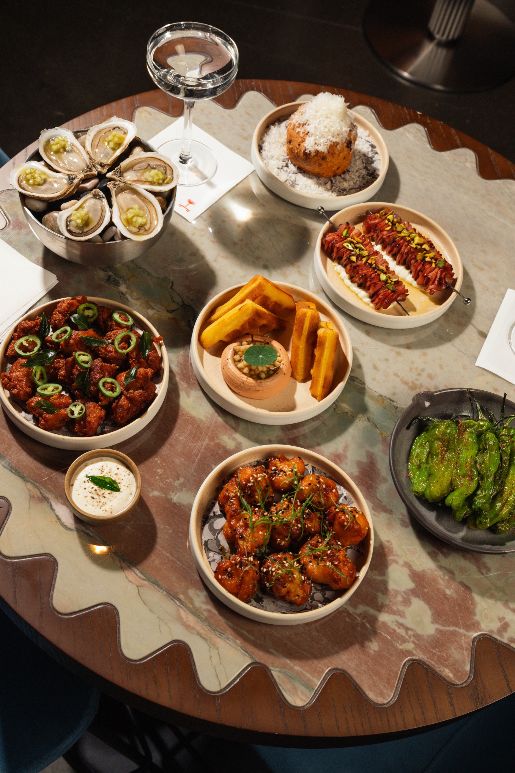 Full menu spread on marble table from above